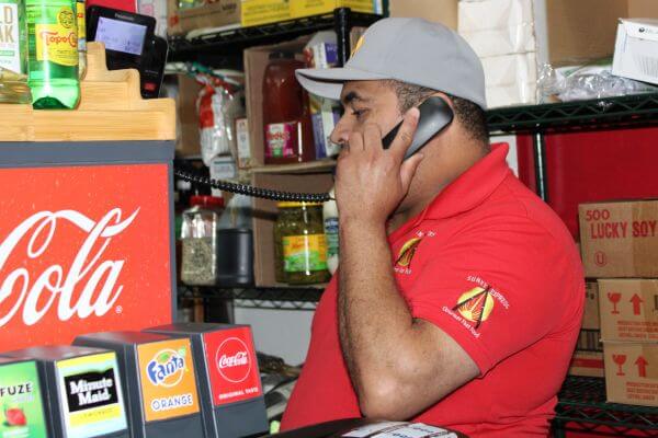 Friendly employee answering the phone at a vegan Mexican and Chinese food restaurant in Compton, serving the Los Angeles area